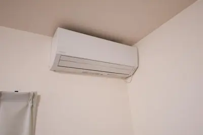 a white air conditioner hanging from a ceiling at Fullhouse 102 in Tokyo
