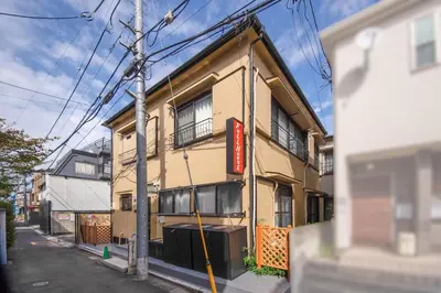 a yellow building with a sign on the side of it at Fullhouse 201 in Tokyo