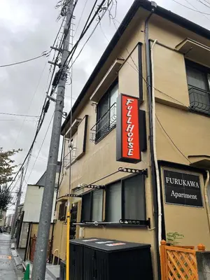 a building with a sign on the side of it at Fullhouse 201 in Tokyo