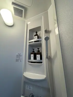 a white refrigerator with two bottles on shelves in a bathroom at Fullhouse 201 in Tokyo