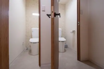 a bathroom with a toilet and a door open at Fullhouse 201 in Tokyo