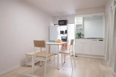 a kitchen with a table and chairs in a room at Fullhouse 202 in Tokyo