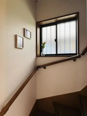 a staircase with a window with a flower in a vase at Lucky you! TATEISHI in Tokyo