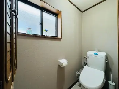 a bathroom with a toilet and a window at Lucky you! TATEISHI in Tokyo