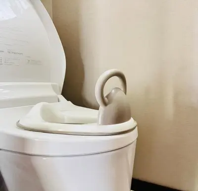 a white toilet with a toy duck on the seat at Lucky you! TATEISHI in Tokyo