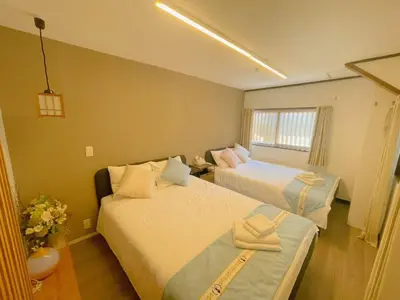 a small room with two beds and a couch at \u5fc3\u306e\u5bbf in Tokyo