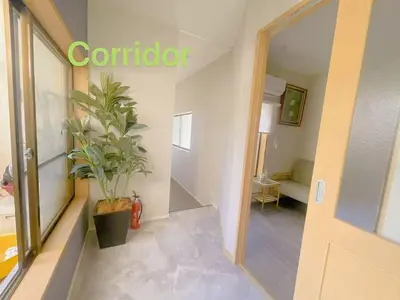 a hallway with a door and a potted plant at \u5fc3\u306e\u5bbf in Tokyo