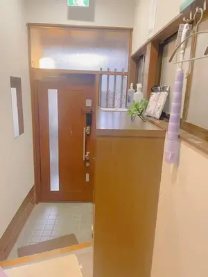 a kitchen with a wooden door and a counter at \u5fc3\u306e\u5bbf in Tokyo