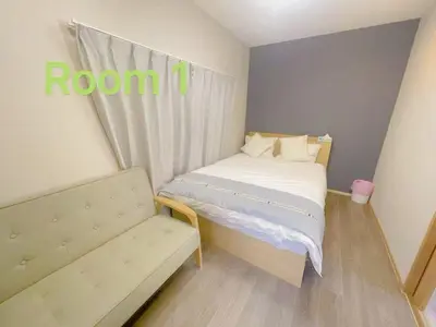 a small bedroom with a bed and a couch at \u5fc3\u306e\u5bbf in Tokyo