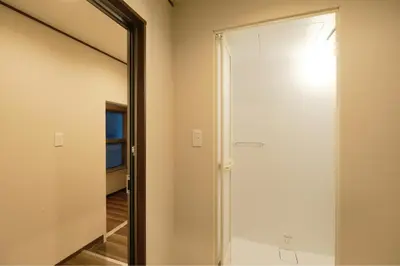 a sliding door in a room with a mirror at ACOE Nakano-Sakaue Holiday Home 5 Minutes to Shinjuku in Tokyo