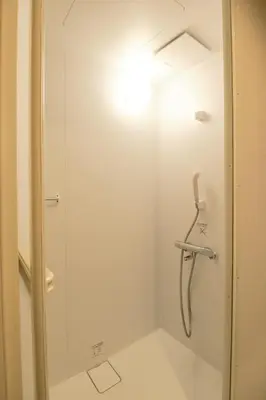 a shower in a bathroom with a glass door at ACOE Nakano-Sakaue Holiday Home 5 Minutes to Shinjuku in Tokyo