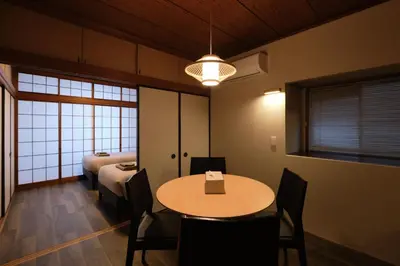 a room with a table and chairs and a bed at ACOE Nakano-Sakaue Holiday Home 5 Minutes to Shinjuku in Tokyo