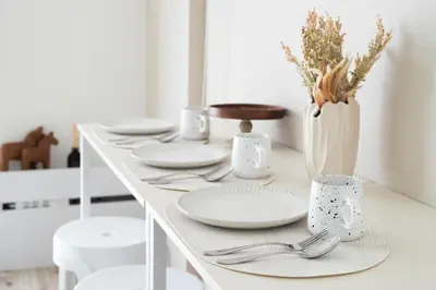 a white table with plates and utensils on it at Latte Oshiage Comfort Stay, 10min walk to Tokyo Skytree in Tokyo