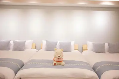 a teddy bear sitting on a bed in a room at \u68ee\u4e0b\u5c0f\u5c4b in Tokyo
