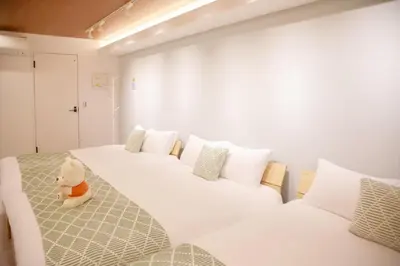 a white teddy bear sitting on a bed in a room at \u68ee\u4e0b\u5c0f\u5c4b in Tokyo