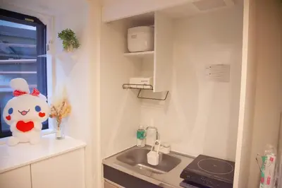 a small kitchen with a sink and a window at \u68ee\u4e0b\u5c0f\u5c4b in Tokyo