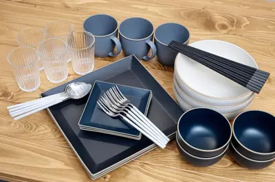 a table with plates and utensils on a table at \u30b3\u30fc\u30c8\u30cf\u30a6\u30b9\u4e09\u8336 in Tokyo