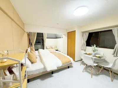 a bedroom with a bed and a table and a desk at F-Mansion210 in Tokyo