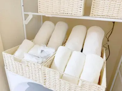 a basket of rolls of toilet paper on a shelf at F-Mansion210 in Tokyo