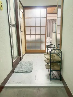 a room with a door and a pile of pillows at Takadanobaba relaxing CB in Tokyo