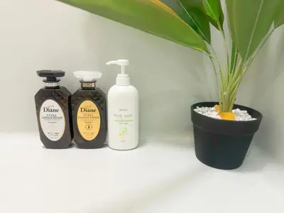 three bottles of soap and a plant on a shelf at Takadanobaba relaxing CB in Tokyo