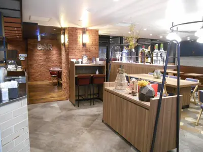 a restaurant with a counter and a bar at Grand Central Hotel in Tokyo