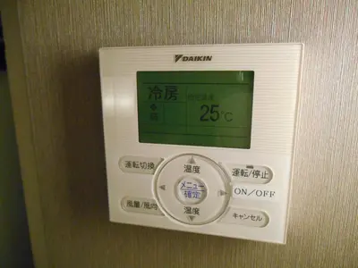 a machine with a clock on the wall at Grand Central Hotel in Tokyo