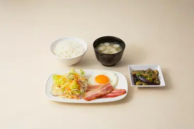 a table with a plate of food and rice at Grand Central Hotel in Tokyo