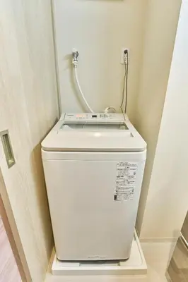 a white toilet in a bathroom with a hose at Nomadland Shinagawa Omori 1104 in Tokyo
