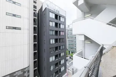 an apartment balcony with a view of a building at Stay Chill Shinbashi in Tokyo