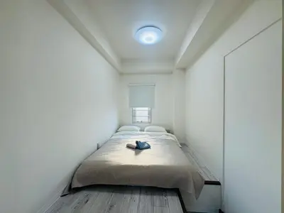 a bedroom with a bed in a white room at LOFT-Hatsudai hostel\u521d\u53f0SY0362 in Tokyo
