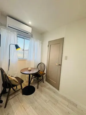 a room with a table and chairs and a window at LOFT-Hatsudai hostel\u521d\u53f0SY0362 in Tokyo