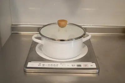 a pot on a stove with a wooden spoon in it at LOFT-Hatsudai hostel\u521d\u53f0SY0362 in Tokyo