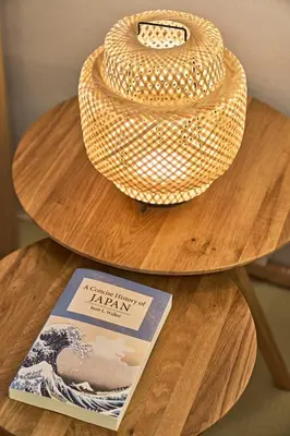 a straw hat sitting on top of a wooden table at IZURU Shiba Hamamatsucho 3F in Tokyo
