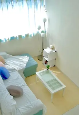 a living room with a bed and a table at bicyclettesumida in Tokyo