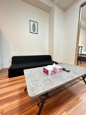 a living room with a couch and a table at SOLASIA residence \u5317\u4e0a\u91ce401 in Tokyo
