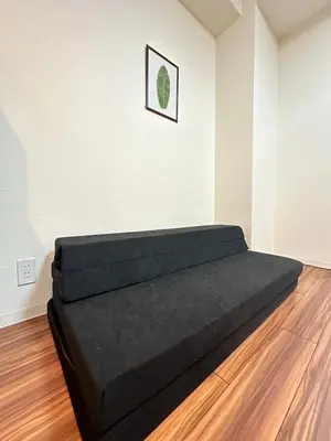 a bed in a room with a picture on the wall at SOLASIA residence \u5317\u4e0a\u91ce401 in Tokyo