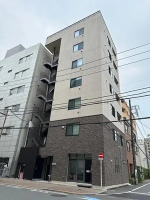 a tall building on the corner of a street at SOLASIA residence \u5317\u4e0a\u91ce401 in Tokyo