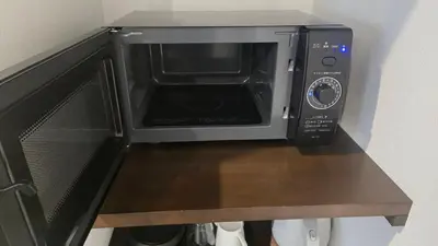 a microwave oven sitting on top of a counter at Port House Honmachi in Tokyo