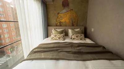 a bedroom with a large bed with a window at LANG HOTEL Asakusa# 3 mins walk to Senso-ji Temple in Tokyo