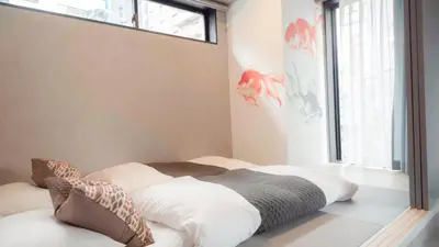 a bed sitting in a room with a window at LANG HOTEL Asakusa# 3 mins walk to Senso-ji Temple in Tokyo