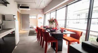 a dining room with a table with orange chairs at LANG HOTEL Asakusa# 3 mins walk to Senso-ji Temple in Tokyo
