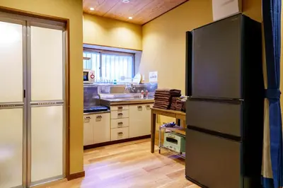 a kitchen with a large refrigerator in a room at NEW Renovated Traditional Japanese House in Sumida in Tokyo