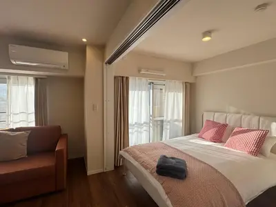 a bedroom with a bed with a black bag on it at Kabukichō, Shinjuku City -13F-SJ0019 in Tokyo