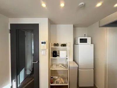 a small kitchen with a refrigerator and a microwave at Kabukichō, Shinjuku City -13F-SJ0019 in Tokyo
