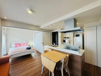 a bedroom with a bed and a table and a kitchen at Kabukichō, Shinjuku City -13F-SJ0019 in Tokyo