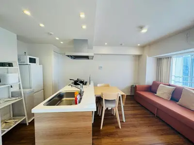 a kitchen and living room with a couch and a table at Kabukichō, Shinjuku City -13F-SJ0019 in Tokyo