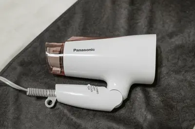 a hair dryer and a hair brush on a table at Horizon Court Shinjuku in Tokyo