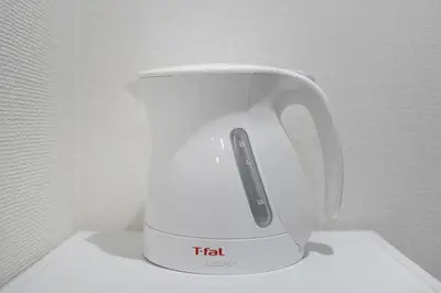 a white tea kettle with a remote control on it at Horizon Court Shinjuku in Tokyo