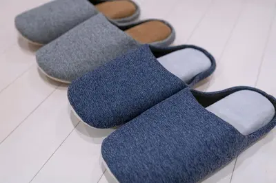 four pairs of blue socks sitting on a floor at Horizon Court Shinjuku in Tokyo